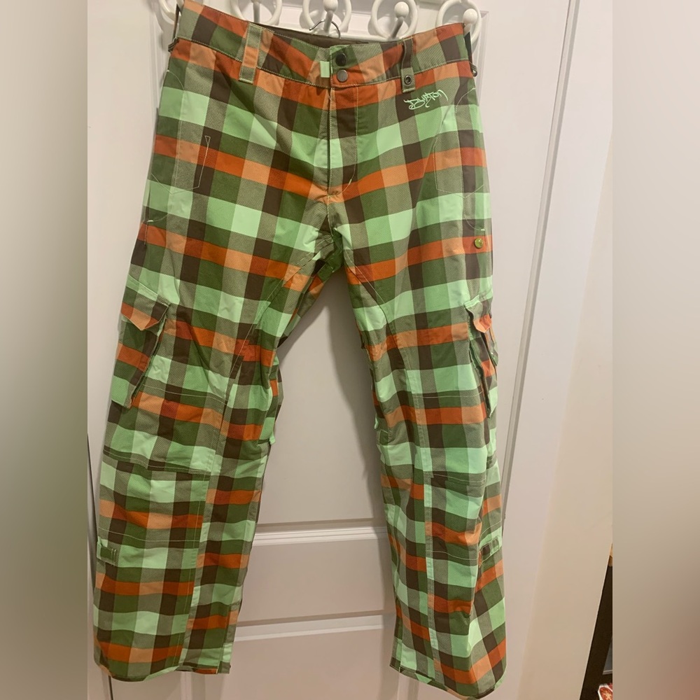 Women’s size large, plaid, cargo-style snowboarding pants.